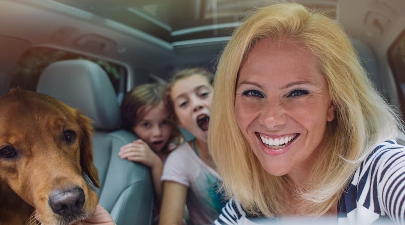 Atlanta-based photographer Kate Parker, pictured with her kids and dog, has a new book filled with girls (and women) finding and using their voices. Image credit: Workman Press.