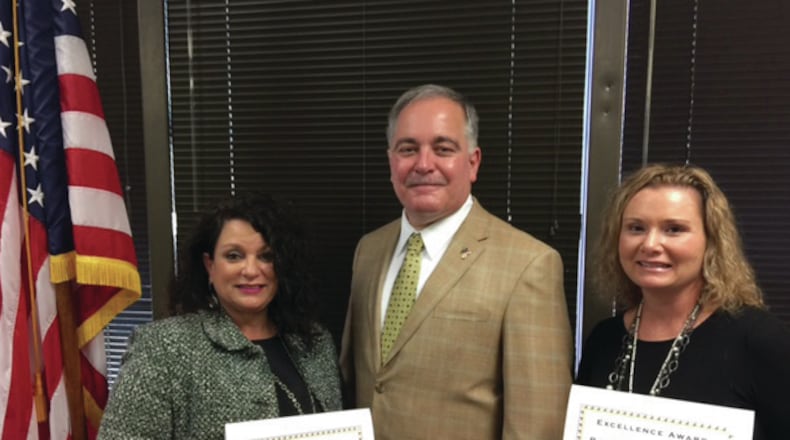 State Superintendent Richard Woods congratulates Free Home Elementary School Principal Karen Carl, 2016 Georgia Distinguished Principal, left; and Woodstock Elementary School Assistant Principal Rachel Wasserman, the Georgia 2016 National Distinguished Assistant Principal.