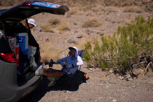 Danny Westergaard takes a break while competing in the Badwater 135 Ultramarathon, Tuesday, July 8, 2025, in Death Valley National Park, Calif. (AP Photo/John Locher)