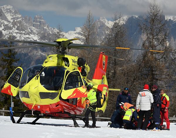 Italy's Federica Brignone is assisted before being flown by helicopter to an hospital, after she broke multiple bones in her left leg during a giant slalom crash at the Italian championships in the Lusia ski area, in Val di Fassa, Italy, Thursday, April 3, 2025. (AP Photo/Elvis Piazzi)