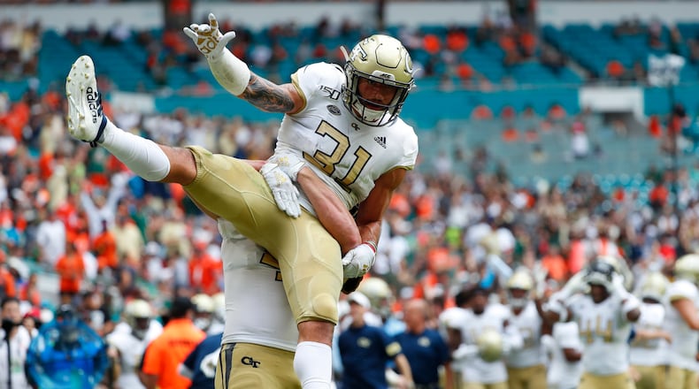Georgia Tech running back Nathan Cottrell (31) is lifted up by tight end Tyler Cooksey during the first half of an NCAA college football game against Miami, Saturday, Oct. 19, 2019, in Miami Gardens, Fla. (AP Photo/Wilfredo Lee)