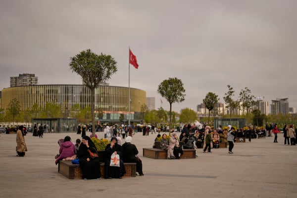 People gather outdoors following an earthquake shock with a preliminary magnitude of 6.2, in Istanbul, Turkey, Wednesday, April 23, 2025. (AP Photo/Khalil Hamra)