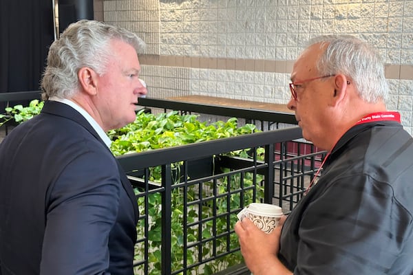 U.S. Rep. Mike Collins, left, R-Ga., speaks to an attendee at the Georgia Republican Convention in Dalton, Ga., Saturday, June 7, 2025. (AP Photo/Jeff Amy)