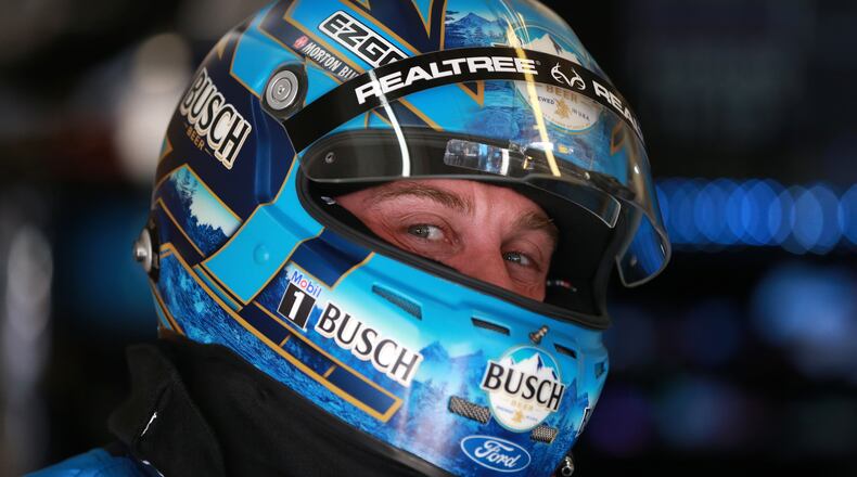 In his garage at Atlanta Motor Speedway, Kevin Harvick flashes a knowing look from beneath his racing armor. (Photo by Sean Gardner/Getty Images)