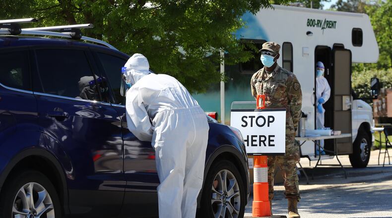 Walmart pharmacist Keri Taylor (left) and Georgia Army National Guard Spc. Korri Jackson help operate a new mobile COVID-19 drive-through testing site to serve rural stretches of Georgia in communites without access to testing at Diamond Lakes Regional Park on Monday, April 27, 2020, in Hephzibah near Augusta. CURTIS COMPTON / CCOMPTON@AJC.COM