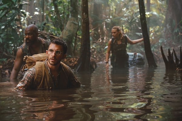 This image released by Universal Pictures and Amblin Entertainment shows, from left, Bechir Sylvain, Jonathan Bailey, and Scarlett Johansson in a scene from " Jurassic World Rebirth." (Jasin Boland/Universal Pictures and Amblin Entertainment via AP)