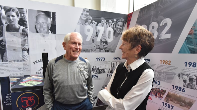 During the 50th anniversary of the Peachtree Road Race in 2019 Julia Emmons (right) celebrated with Bill Thorn. Thorn was the only individual who ran the race every one of those first 50 years. The two are seen at an unveiling of a traveling exhibit on the race. HYOSUB SHIN / HSHIN@AJC.COM