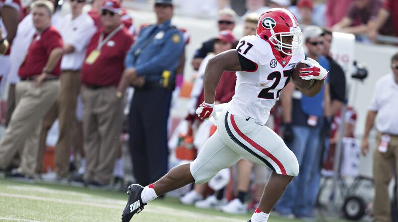 Nick Chubb #27 of the Georgia Bulldogs rushes for a touchdown against the Arkansas Razorbacks at War Memorial Stadium on October 18, 2014 in Little Rock, Arkansas. The Bulldogs defeated the Razorbacks 45-32. (Photo by Wesley Hitt/Getty Images)