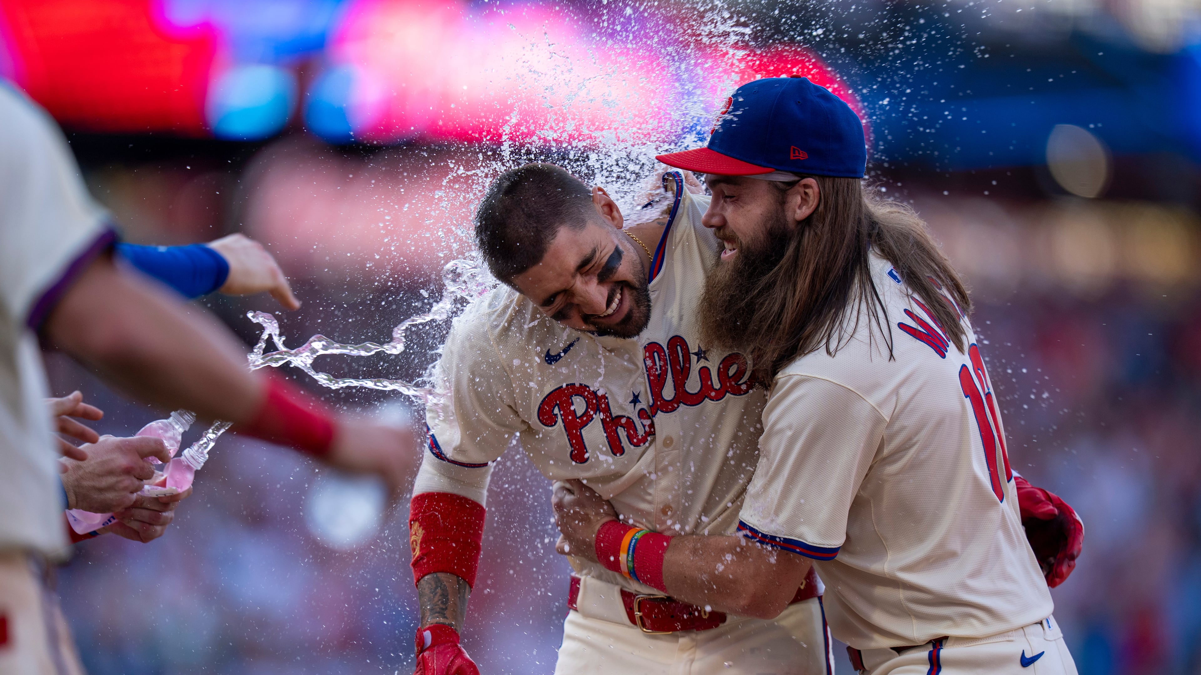 Philadelphia Phillies' Nick Castellanos, left, celebrates with Brandon Marsh, right, and other teammates after driving in the winning run during the 10th inning of a baseball game against the Minnesota Twins, Sunday, Sept. 28, 2025, in Philadelphia. (AP Photo/Chris Szagola)