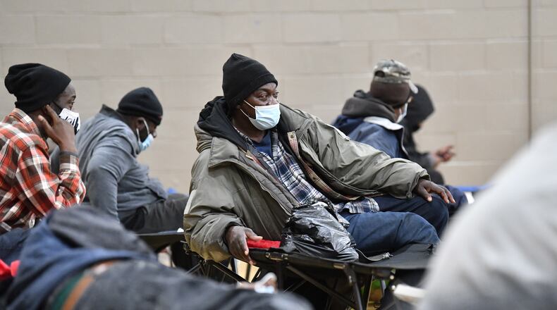 December 22, 2022 Atlanta - Cassius King (center) sits on a cot at the Old Adamsville Recreation Center warming center on Thursday, December 22, 2022. The City of Atlanta recently announced to open multiple warming centers as temperatures drop across metro Atlanta. (Hyosub Shin / Hyosub.Shin@ajc.com)