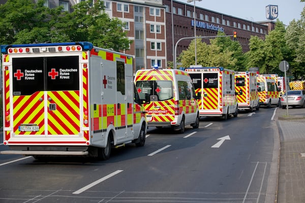 Ambulances drive to the Eduardus Hospital in Cologne-Deutz to evacuate the hospital before specialists defuse three unexploded U.S. bombs from World War II that were unearthed earlier this week in Cologne, Wednesday, June 4, 2025. (Henning Kaiser/dpa via AP)