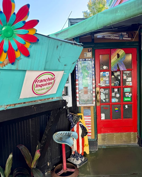 R. Thomas Deluxe Grill has a new addition by the entrance: a sign advertising franchise opportunities. (Henri Hollis/AJC)