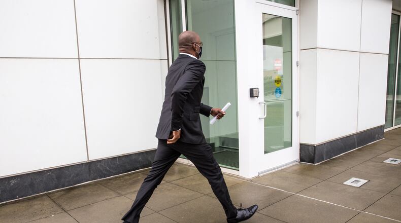 Jim Beard the City of Atlanta's former CFO, leaves the Richard B. Russell Federal Building in Atlanta jogging to the car of one of his attorneys, Brittany Cambre on Thursday, Sept 17, 2020.  Beard ran to her car after entering a plea of not guilty to multiple federal charges.  (Jenni Girtman for The Atlanta Journal-Constitution)