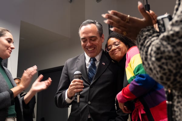 Public Service Commission candidate Peter Hubbard gets a hug from Brionté McCorkle, executive director of Georgia Conservation Voters, during an election night party in Southwest Atlanta on Tuesday, Nov. 4, 2025.   (Ben Gray for the AJC)