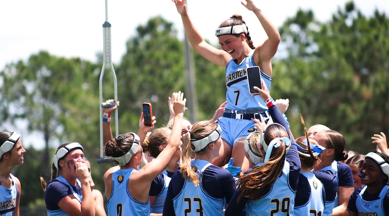 Warner University quarterback Kathryn Hutchinson (top), a River Ridge High grad, celebrates with teammates after the Royals won the Sun Conference Tournament championship Saturday, April 25, 2026, in Lake Wales, Florida. Hutchinson was named tournament MVP after the 25-14 win over Keyser University. (Courtesy of Reese Mole/Warner University)