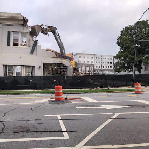 A demolition crew knocks down the historic Saye Building in downtown Athens on Thursday, July 31, 2025. The removal of the 22,000-square-foot structure has prompted proposed changes to Athens-Clarke County’s demolition permitting process. (Jim Thompson for the AJC)