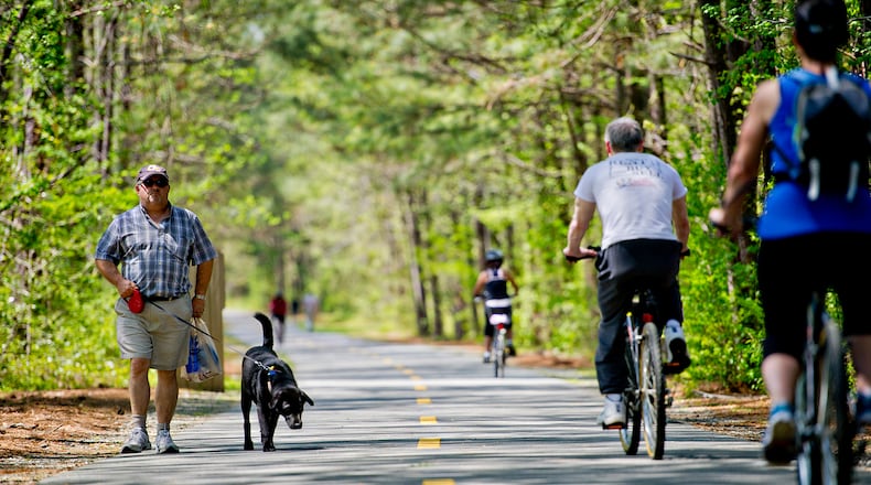 Steve O'Neill (left) walks his dog, Murphy, on the Silver Comet Trail in Mableton.