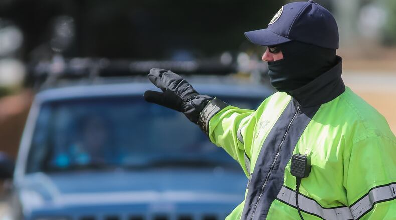 Officer J. Davis, who directed traffic on Wieuca Road on Mon., Feb. 8, 2016, bundled up to protect himself against the cold. JOHN SPINK / JSPINK@AJC.COM