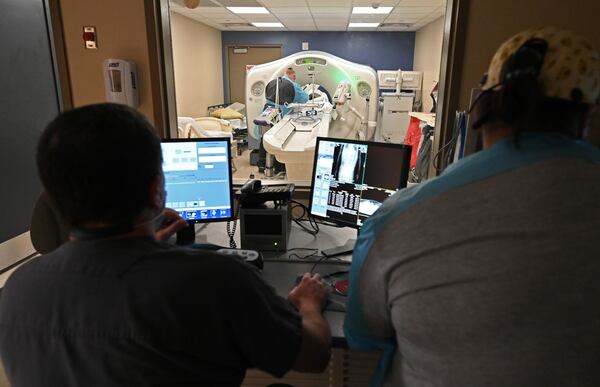 Radiology Manager Danny Everson, left, supervises a CT scan at Miller County Hospital on Monday. One of CEO Robin Rau's first priorities after taking over the hospital was to upgrade its electrical and plumbing systems to handle technology like CT scans, MRIs and other health screenings. (Hyosub Shin / Hyosub.Shin@ajc.com)