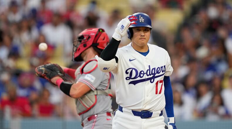 Los Angeles Dodgers' Shohei Ohtani, right, walks back to the dugout after striking out as Cincinnati Reds catcher Tyler Stephenson throws the ball back during the third inning of a baseball game Monday, Sept. 7, 2026, in Los Angeles. (AP Photo/Mark J. Terrill)