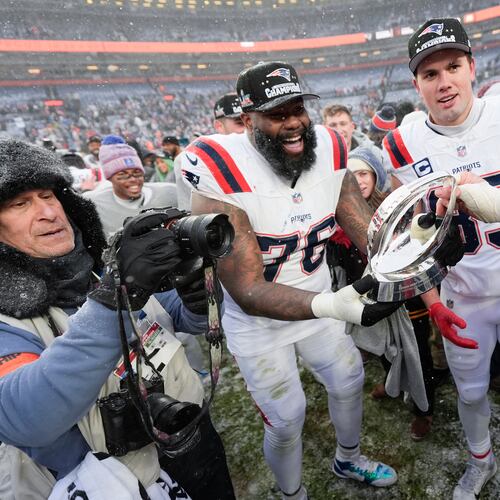 New England Patriots offensive tackle Morgan Moses (76) and tight end Hunter Henry celebrate after the AFC Championship NFL football game against the Denver Broncos, Sunday, Jan. 25, 2026, in Denver. (AP Photo/Ashley Landis)