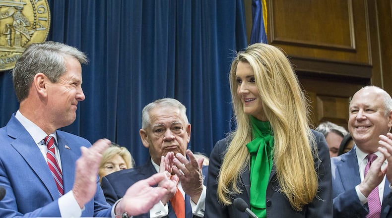 Lawmakers applaud as newly appointed U.S. Sen. Kelly Loeffler (second from right) is introduced by Georgia Gov. Brian Kemp (left) during a press conference Wednesday, Dec, 4, 2019. Georgia Gov. Brian Kemp appointed Loeffler to the U.S. Senate to take the place of Johnny Isakson, who is stepping down for health reasons. (ALYSSA POINTER/ALYSSA.POINTER@AJC.COM)