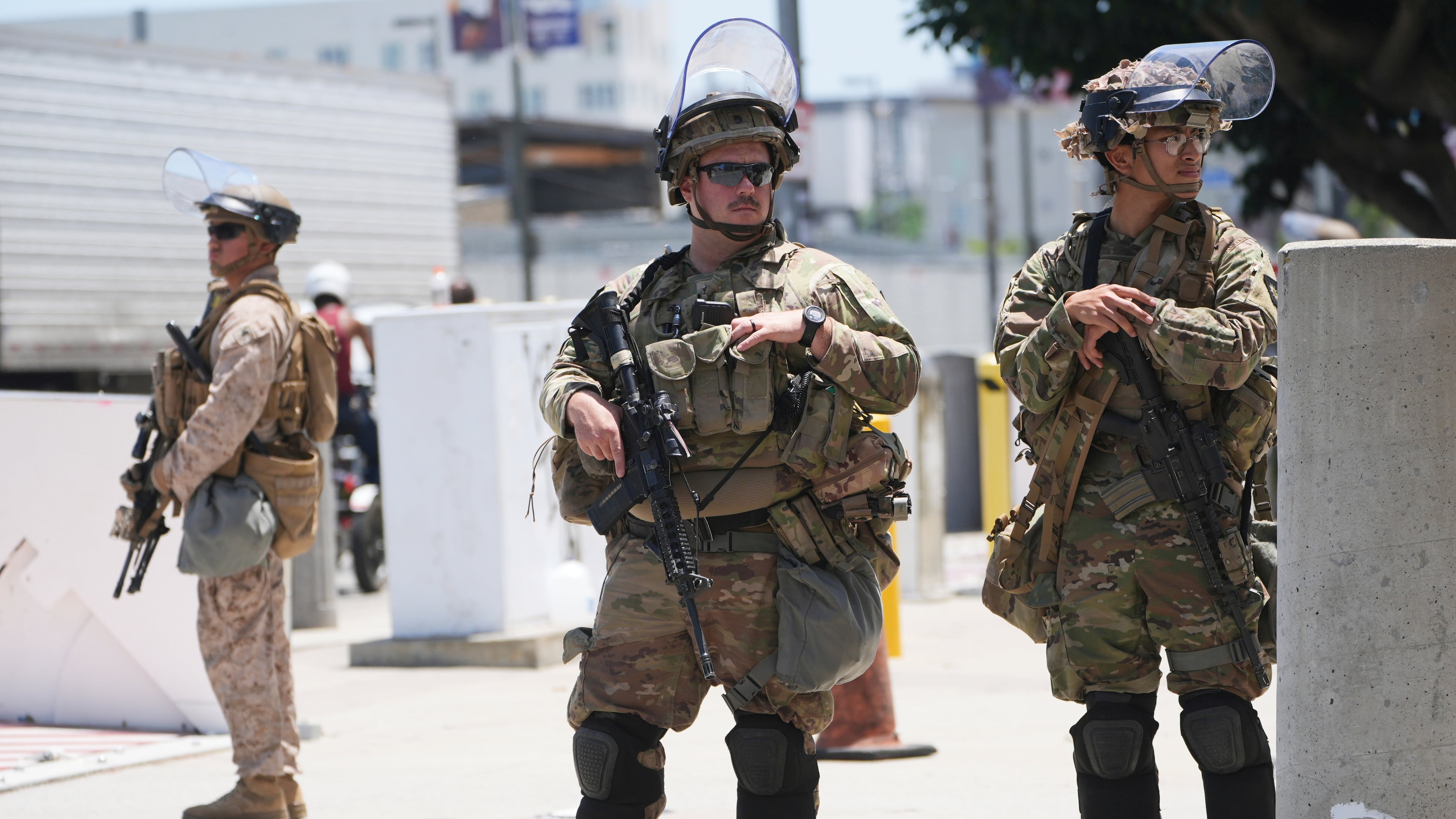 FILE - Members of the California National Guard and U.S. Marines guard a federal building on Tuesday, June 17, 2025, in Los Angeles. (AP Photo/Damian Dovarganes, File)