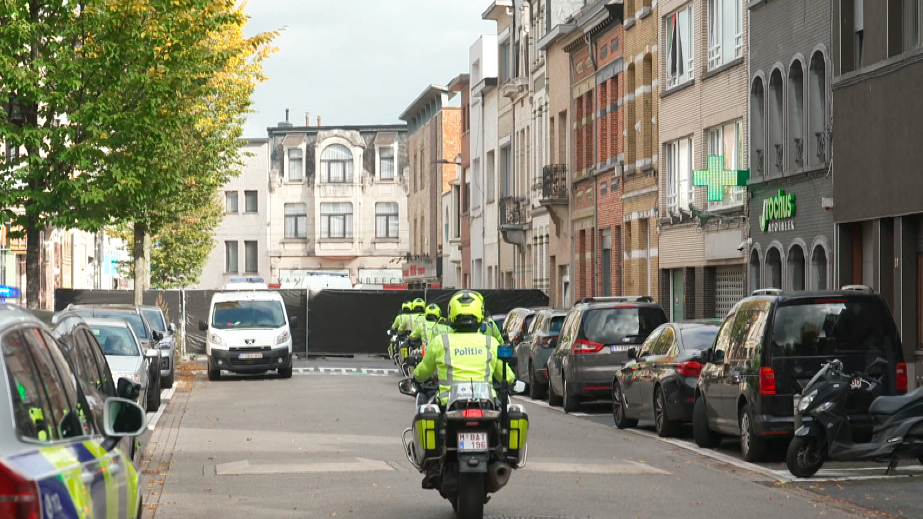 In this image taken from video provided by VTM, police on motorcycles drive toward a black police cordon set up in a street during an investigation in Antwerp, Belgium, Thursday, Oct. 9, 2025. (VTM via AP)