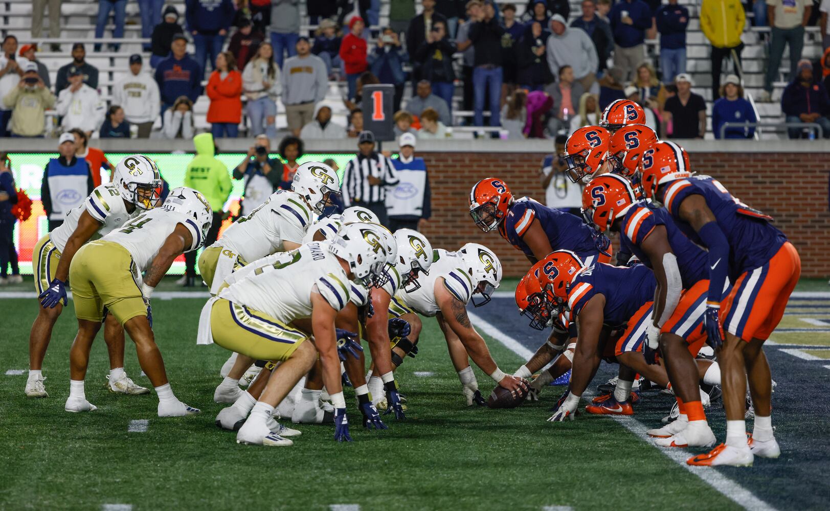 Georgia Tech players prepare to take a knee at the end of an NCAA college football game between Georgia Tech and Syracuse, 31-22, in Atlanta on Saturday, Nov. 18, 2023.  (Bob Andres for the Atlanta Journal Constitution)