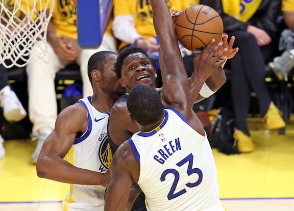 Minnesota Timberwolves' Anthony Edwards tries to score between Golden State Warriors' Draymond Green and Jonathan Kuminga in 2nd quarter during NBA Western Conference Semifinals' Game 3 at Chase Center in San Francisco on Saturday, May 10, 2025. (Scott Strazzante/San Francisco Chronicle via AP)