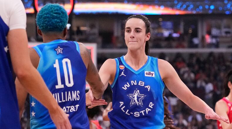 Team Spoon's Caitlin Clark, right, celebrates with Courtney Williams (10) after their team defeated Team Coop in a WNBA All-Star basketball game in Chicago, Saturday, July 25, 2026. (AP Photo/Nam Y. Huh)