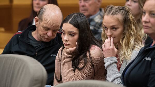 Richard Doran, from left, grandfather of Jordan Holgerson, center, friend Ryan Anderson and Genelle Holgerson, mother of Jordan Holgerson, react after the sentencing of Tay'Lor Smith at the Clark County Courthouse in Vancouver, Wash., on Wednesday, March 27, 2019. Smith pleaded guilty to pushing her friend Jordan Holgerson from a bridge at a popular swimming area near Vancouver, in August.