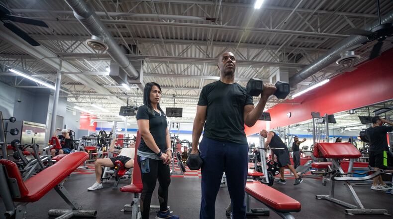 Christopher Ireland, CEO of RideShare, trains with Annabelle Tapponnier at Workout Anytime Gym in Marietta, Ga., on Thursday, Sept. 2, 2021. (Photo/Jenn Finch, The Atlanta Journal-Constitution)