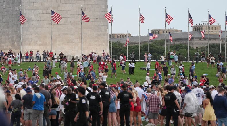 Law enforcement secure the area as people evacuate because of incoming storms that will delay the program at a Salute to America Independence Day event honoring the nation's 250th anniversary, Saturday, July 4, 2026, on the National Mall in Washington. (AP Photo/Alex Brandon)