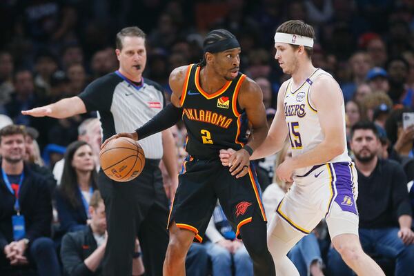 Oklahoma City Thunder guard Shai Gilgeous-Alexander (2) looks for an outlet against Los Angeles Lakers guard Austin Reaves (15) during the first half of an NBA basketball game Sunday, April 6, 2025, in Oklahoma City. (AP Photo/Nate Billings)