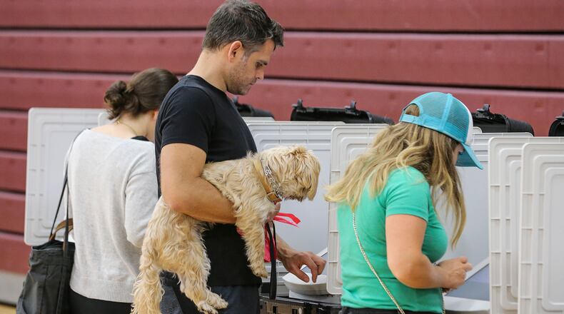 November 7, 2017 Atlanta: Garrett Clum brought his dog, Beau to vote on Tuesday. Voters lined up early at Henry W. Grady High School at 929 Charles Allen Dr NE in Atlanta on Tuesday, Nov. 7, 2017 to cast their votes. Only about 20,000 of 250,000 registered voters cast early ballots in Atlantaâs mayoral election, a likely sign of low turnout for Tuesdayâs vote to succeed Atlanta Mayor Kasim Reed. A late WSB-TV poll, released on Friday, showed Councilwoman Keisha Lance Bottoms leading Councilwoman Mary Norwood for the first time with 25 percent of the vote to Norwoodâs 23 percent.  JOHN SPINK/JSPINK@AJC.COM