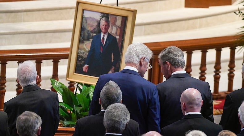 Former Presidents Bill Clinton talks to George W. Bush, right, as they and Jimmy Carter, left, attend the funeral for former Governor and U.S. Senator Zell Miller held at Peachtree Road United Methodist Church, Tuesday March 27, 2018, in Atlanta. Miller, a conservative democrat, died at 86 from complications from Parkinson's disease four days ago on March 23 at his home in Young Harris, Ga. (John Amis)