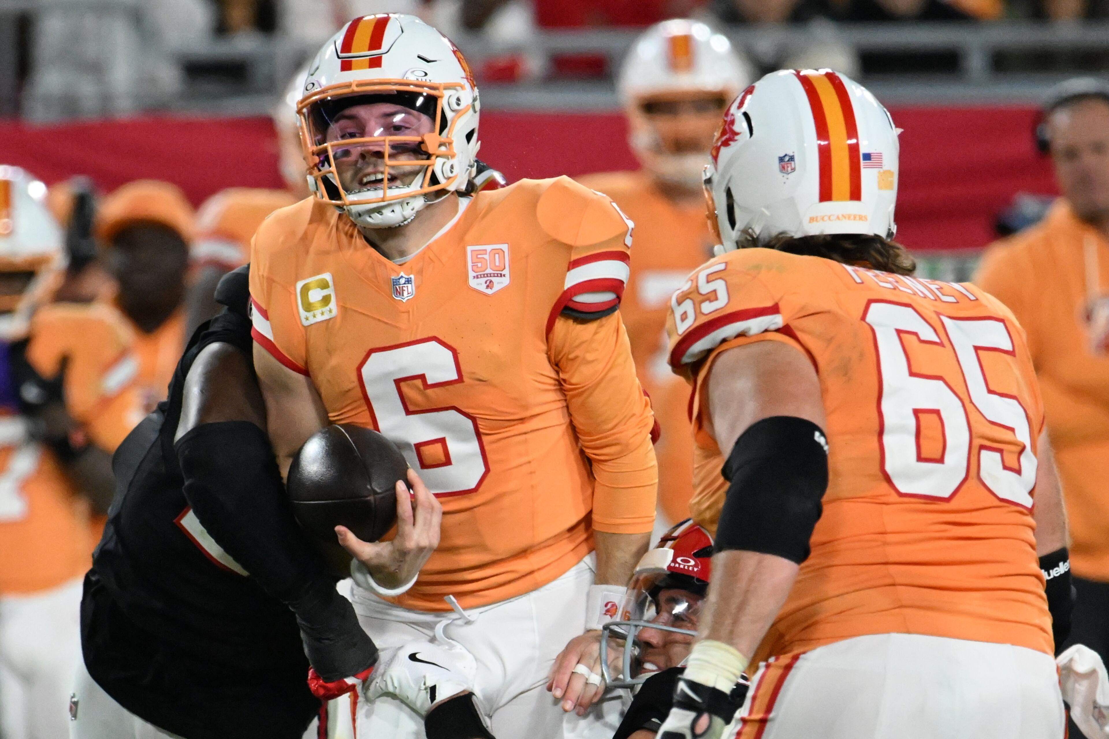 Tampa Bay Buccaneers quarterback Baker Mayfield (6) runs against the Atlanta Falcons during the first half of an NFL football game, Thursday, Dec. 11, 2025, in Tampa, Fla. (AP Photo/Jason Behnken)