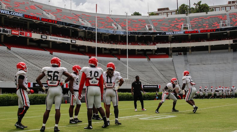 Georgia defensive football players gather for drills at practice Saturday, Aug., 18, 2018, at Sanford Stadium in Athens.