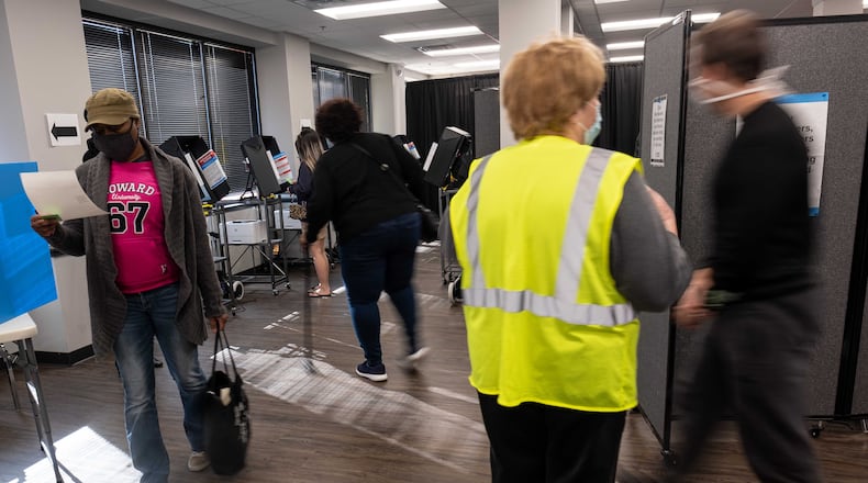 Kesha Johnson checks her printed ballot before casting it during early voting at the Cobb County Elections office in Marietta on Saturday, Dec. 19, 2020. (Photo: Ben Gray for The Atlanta Journal-Constitution)