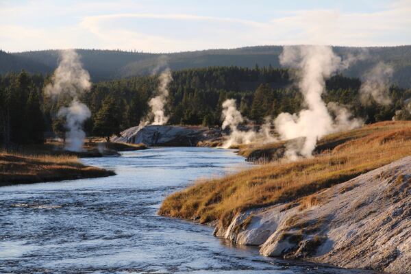 Geysers and other geothermal features emit steam at the Upper Geyser Basin of Yellowstone National Park, Sept. 25, 2023. (AP Photo/Hannah Schoenbaum)