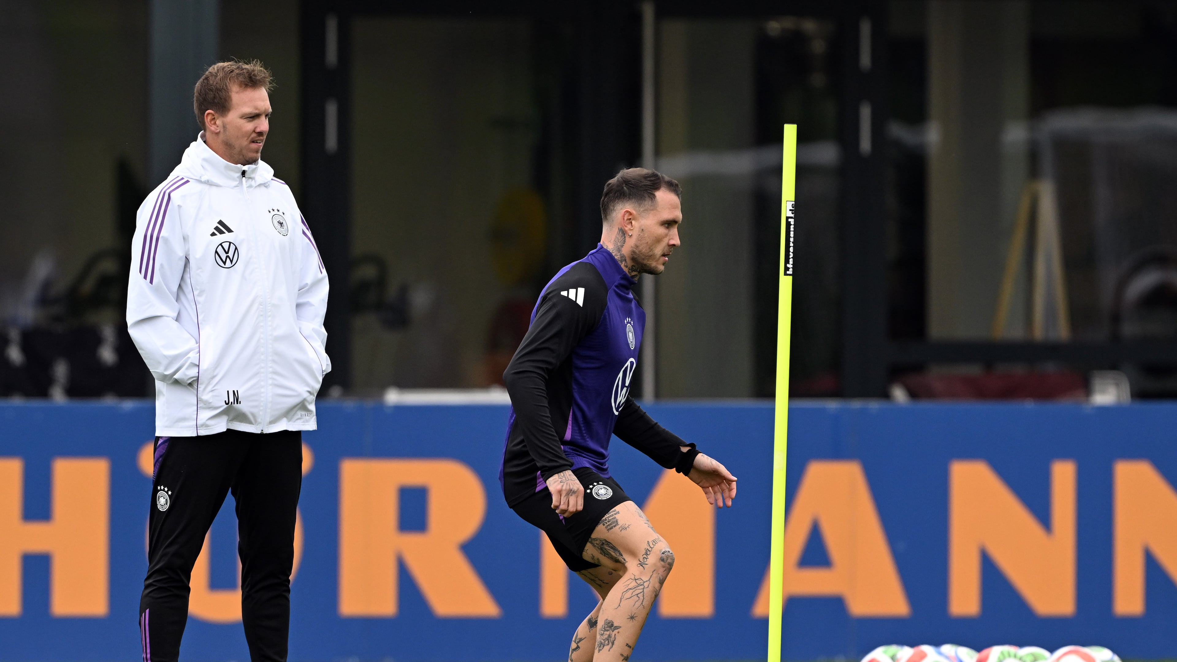 Germany's head coach Julian Nagelsmann, left, and player david Raum attend a training session of the German national soccer team in Herzogenaurach, Germany, Tuesday, Oct. 7, 2025, ahead of the World Cup qualifier soccer match against Luxembourg. (Federico Gambarini/dpa via AP)