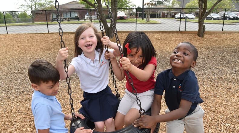 Kindergartners (from left) Ian DeOliviera, Eden Sterling, Ximena Benitez and Adam Ajayi, all 6, play at Carman Adventist School in Marietta earlier this month. These kids represent the new Cobb County, a county that is within just a few years of becoming majority minority. HYOSUB SHIN / HSHIN@AJC.COM