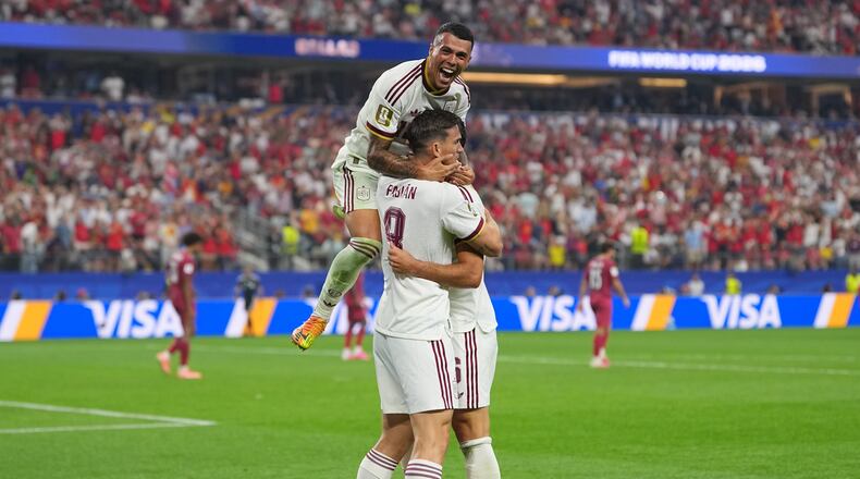 Spain's Pedro Porro, top, congrats Spain's Mikel Merino, right, after scored during the World Cup round of 16 soccer match between Portugal and Spain in Arlington, Texas, near Dallas, Monday, July 6, 2026. (AP Photo/Julio Cortez)