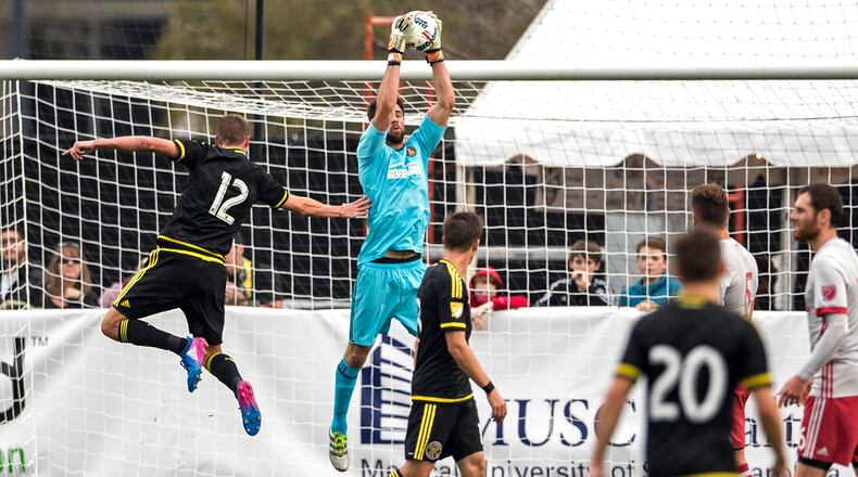Charleston, South Carolina - February 18, 2017: Atlanta United goalie Alec Kann grabs the ball out of the air and keeps Crew forward Adam Jahn (#12) from connecting with it on Saturday, Feb. 18, 2017 in Charleston. (Photo by Alex Holt)