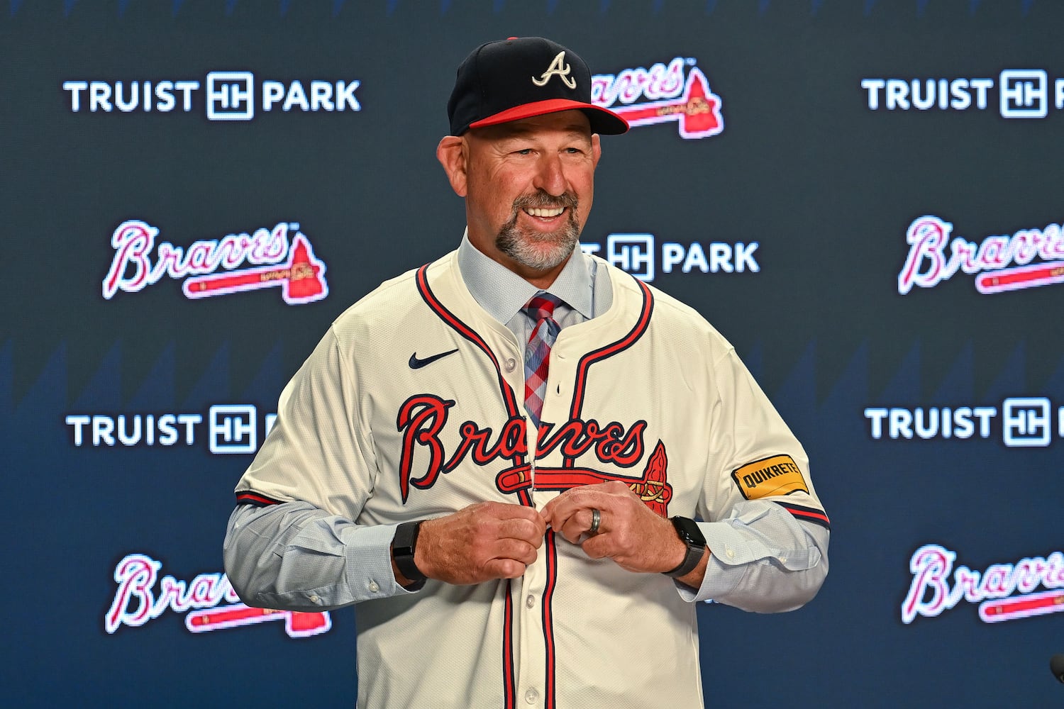 Newly hired Braves manager Walt Weiss buttons his jersey during a news conference Tuesday, Nov. 4, 2025, at Truist Park in Atlanta. (Daniel Varnado for the AJC)