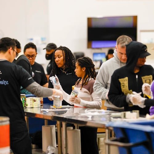 Volunteers pack food at the Hunger Action Center at the Atlanta Community Food Bank. Around the South, people are taking care of their neighbors who lost SNAP benefits Saturday.