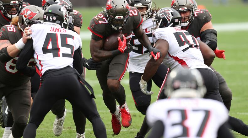 Tampa Bay Buccaneers running back Ronald Jones (27) finds a hole in the Atlanta Falcons defense during the first half Sunday, Jan. 3, 2021, in Tampa, Fla. (Mark LoMoglio/AP)
