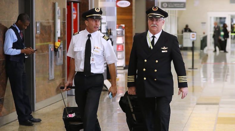 Delta pilots arrive from Stuttgart in the International Terminal at Hartsfield Jackson International Airport earlier this month. The proposed $2 trillion aid package being worked on in Congress has billions for the airline industries. Curtis Compton ccompton@ajc.com