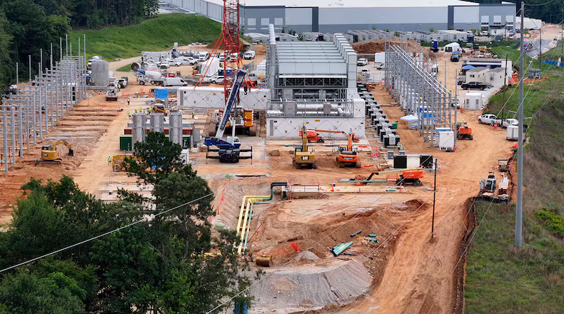 Aerial view of off-grid generators being installed, with the data center in the background, on Thursday, June 25, 2026, in Covington. A data center near Social Circle plans to get its primary power supply from a set of off-grid generators, the first setup of its kind in Georgia. But the company behind the power project is already installing its equipment, despite never obtaining proper permits from the state, a move environmental advocates say raises serious questions about oversight of data centers cropping up across Georgia. (Hyosub Shin/AJC)